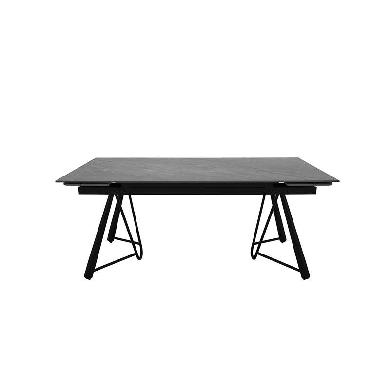 Mesa de comedor extensible de color gris oscuro con superficie de cerámica y base de pedestal metálico, vista frontal.