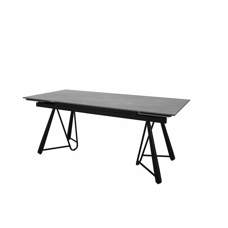 Mesa de comedor extensible Yad de Deurope, en gris oscuro con superficie de cerámica y base de metal, vista frontal.