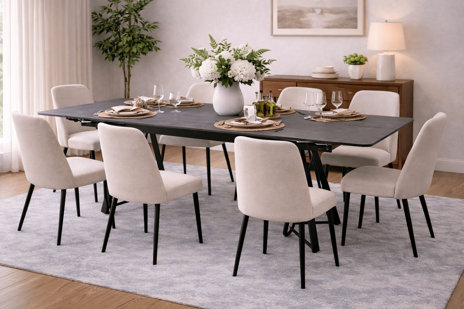 Mesa de comedor extensible Yad de color gris oscuro con superficie de cerámica y base metálica, vista frontal.